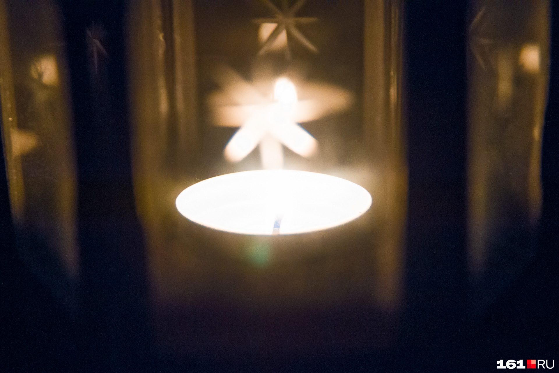 старинная комната со свечёй. вечернее окно. свечка на подоконнике. полумрак в комнате. горящая свеча у иконы.