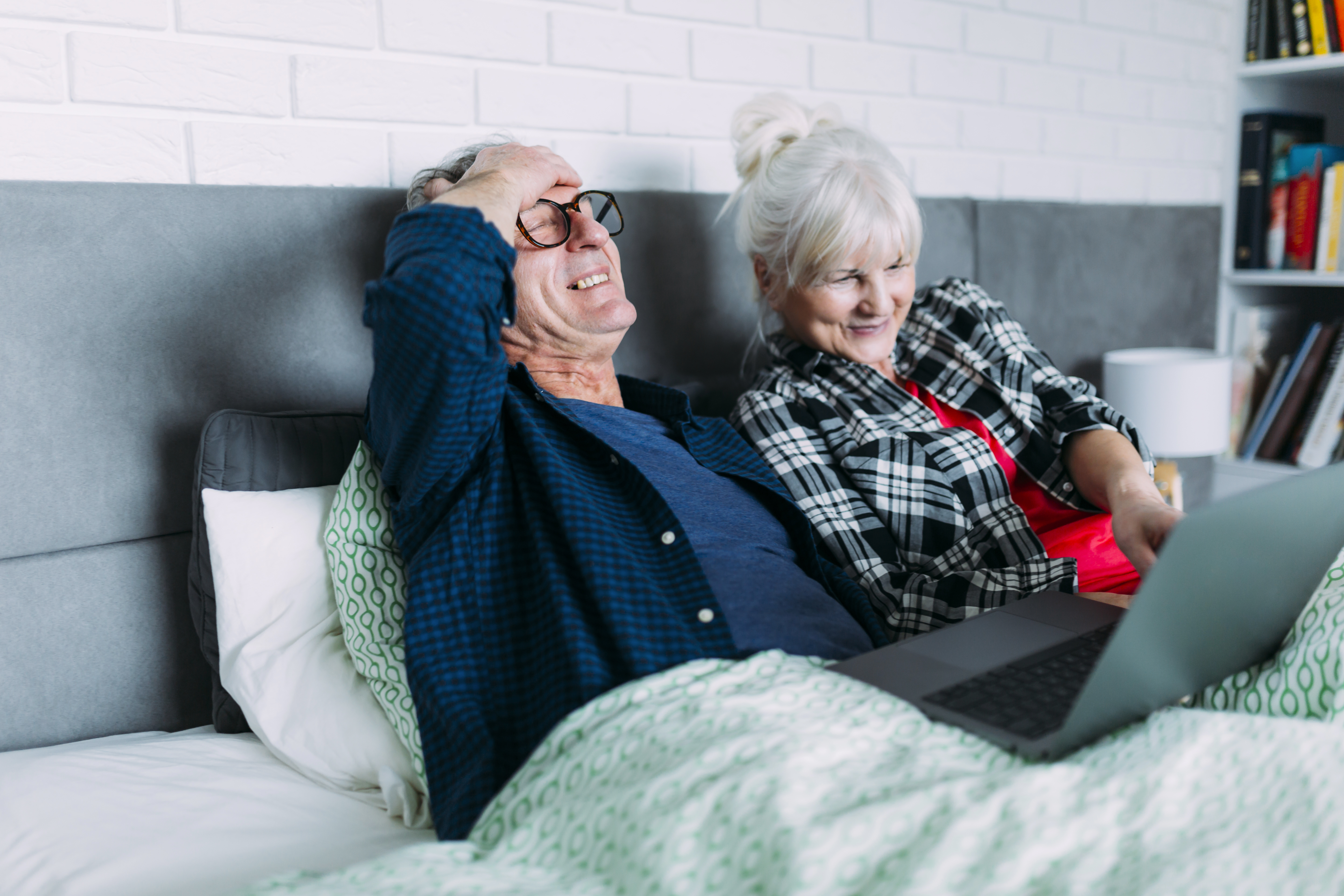 happy-elderly-couple-bed-with-laptop.jpg