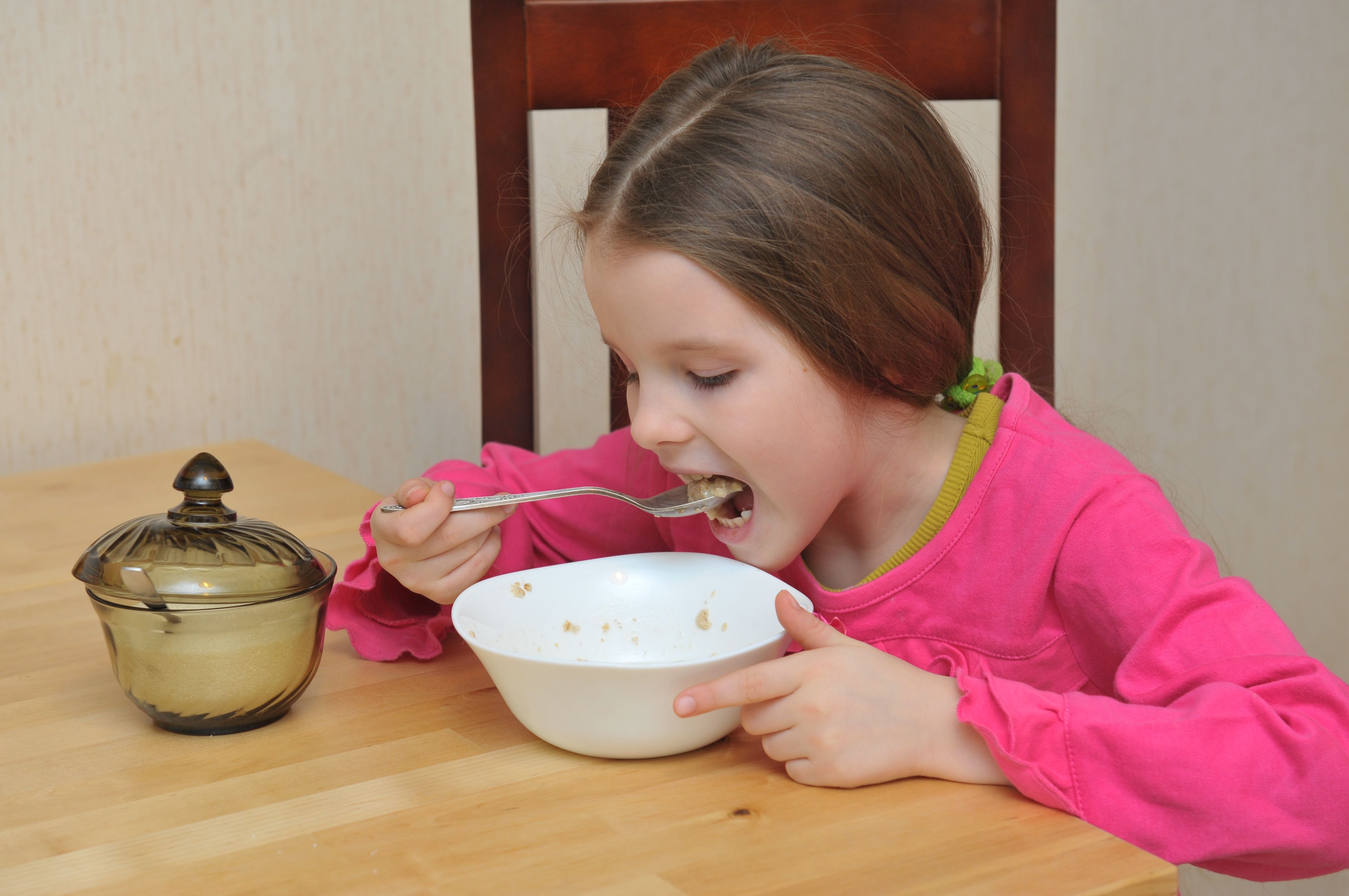 Girl serve porridge