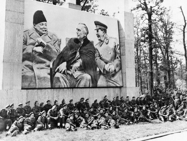 На Потсдамской конференции, в английском отряде Крыс пустыни, находится гигантское изображение Трех Великих: Черчилля, Трумэна и Сталина в Аллемане 17 июля 1945 года. (Фото Keystone-France\Gamma-Rapho через Getty Images) - Sputnik Абхазия