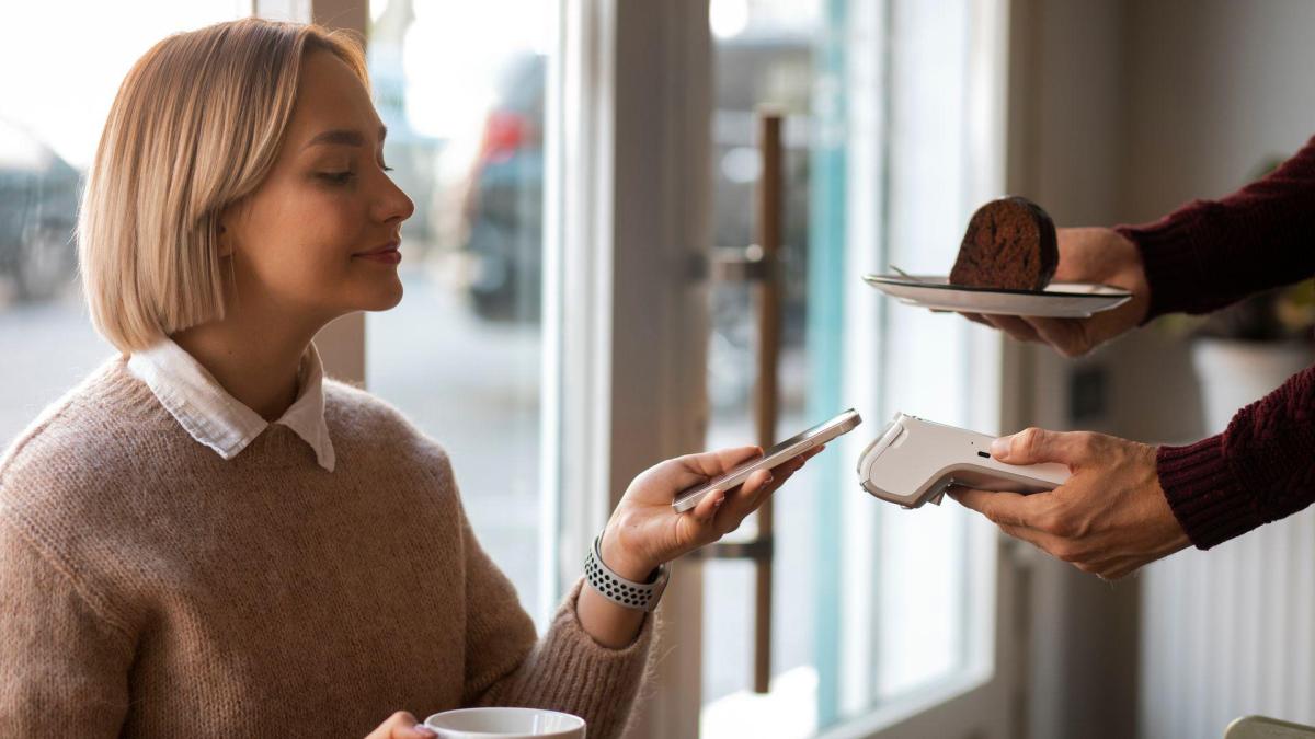 person-using-nfc-technology-pay-restaurant