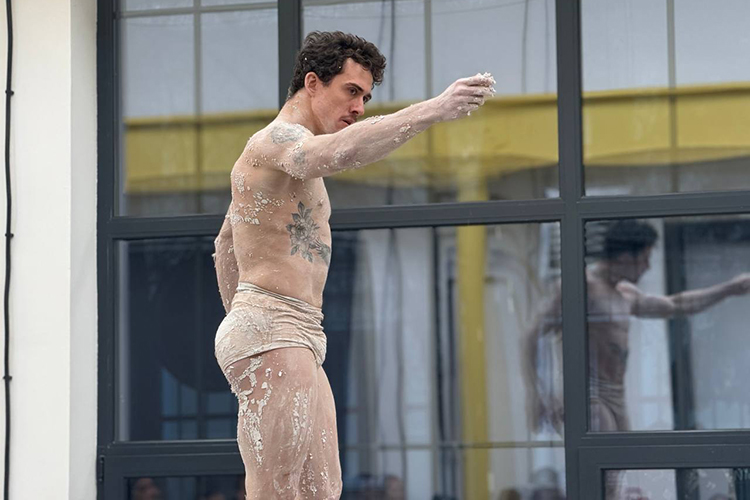 В пространстве «Открытых мастерских» при обычном свете по центру условной сцены на крутящемся постаменте стоит облепленный гипсом перформер — это премьер балета театра им. Джалиля, заслуженный артист РТ, бразилец Вагнер Карвальо