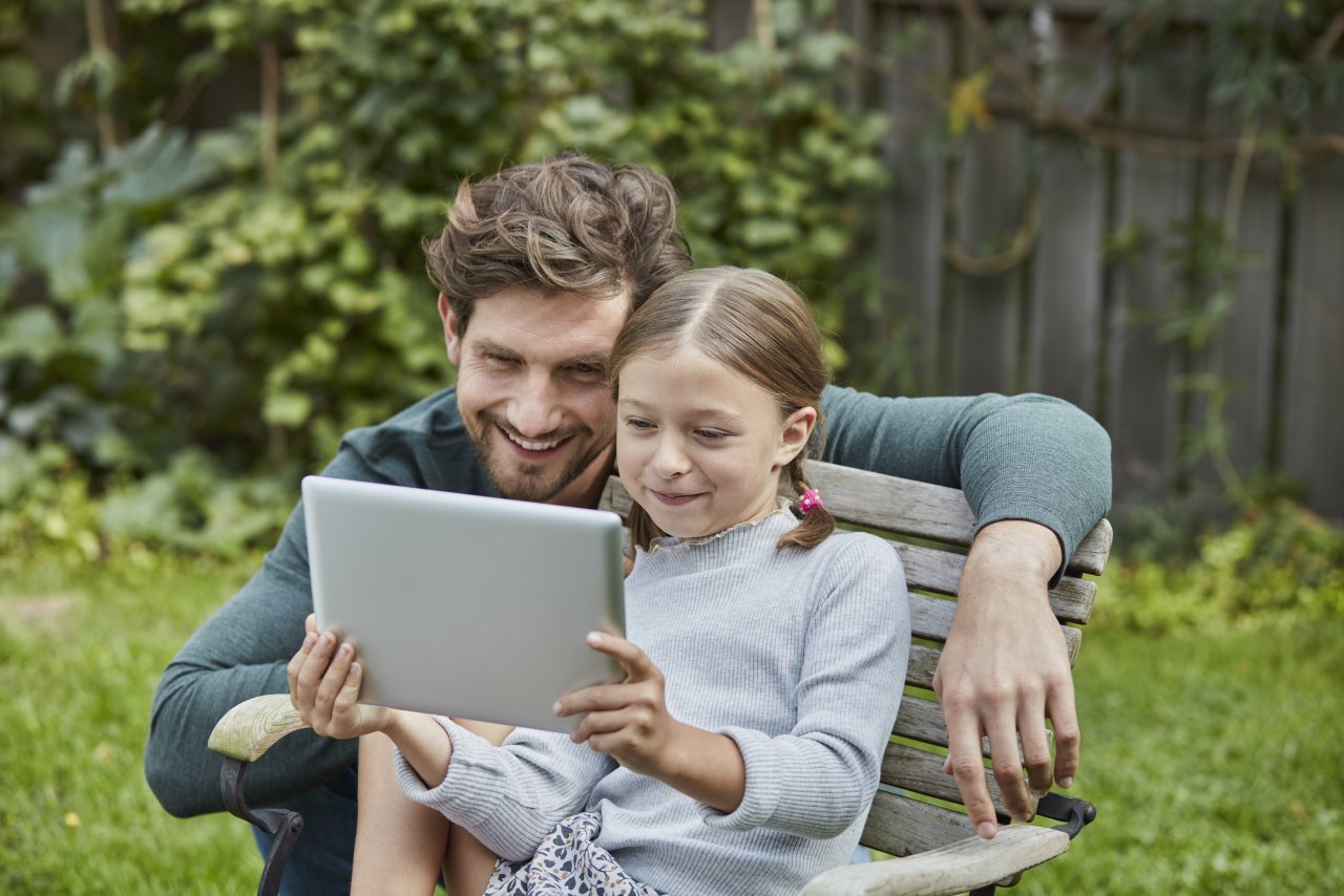 Live user. Father and daughter using Tablet Computer.