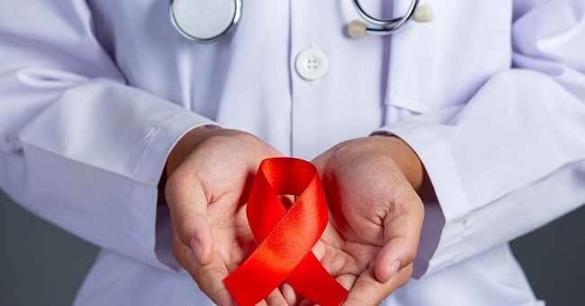 The doctor holds a red ribbon, HIV awareness awareness, World AIDS Day and World Sexual Health Day.