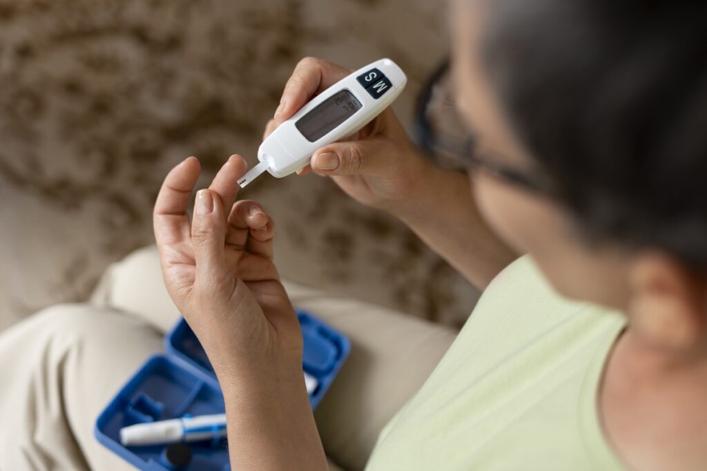 high angle diabetic woman checking her glucose level