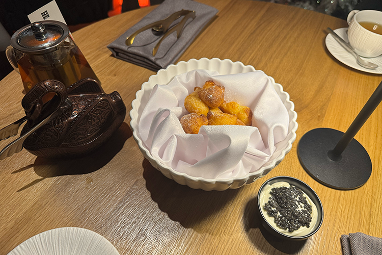 «Вздохи монашки» — пончики, присыпанные сахарной пудрой, с кремом из белого шоколада и черной осетровой икрой