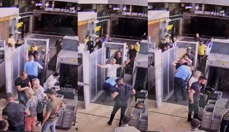 Польский посол (на фото в центре) и его охрана покидают Екатеринбург